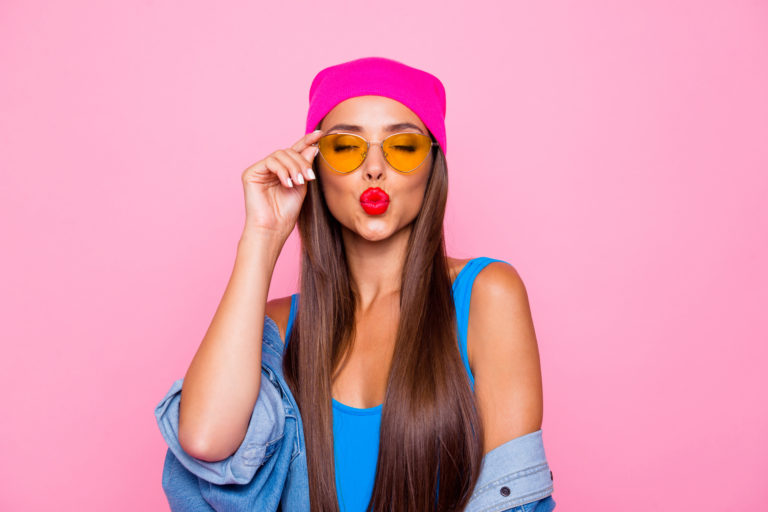 Close up photo portrait of winsome pretty cute lovely sweet glad nice lady sending kiss to you wearing orange transparent glasses closed eyes isolated pastel background