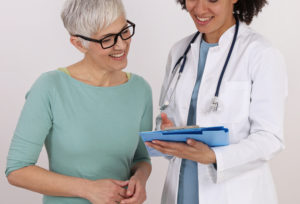 Doctor and mature female Patient discussing treatments for menopause.