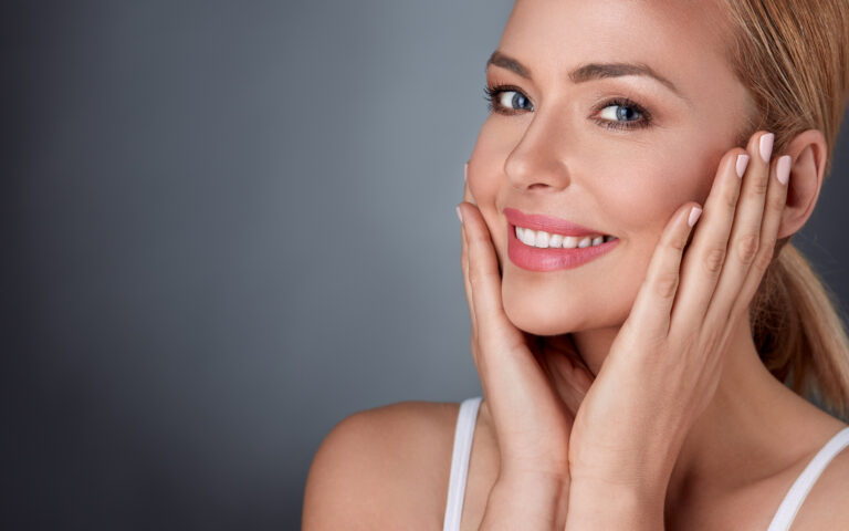 young woman holding cheeks smiling